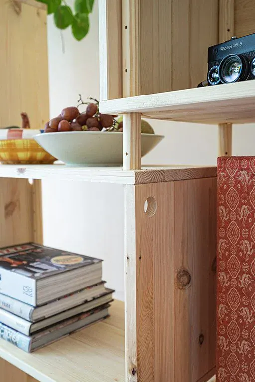 Close-up of an RMC shelf with a bowl of grapes, a camera and a stack of books