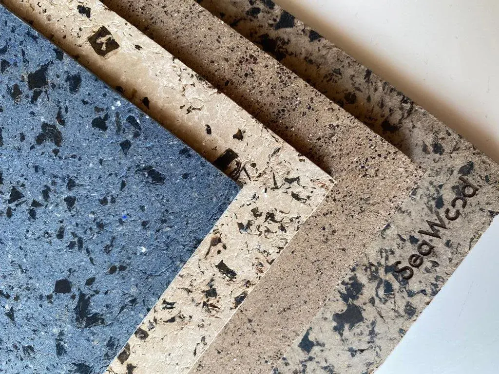 Stack of blue and cream SeaWood boards, pressed from brown seaweed